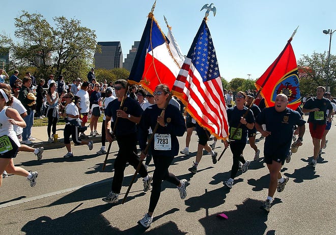 Patriotism was a recurring theme among runners in this years' Capitol 10,000.  This group of Austin firefighters was approaching the finish line. [Larry Kolvoord/American-Statesman]