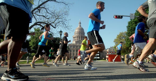 Runners make their way west on 15th Street during the 2012 Capitol 10,000 in Austin, TX. [Jay Godwin/American-Statesman]